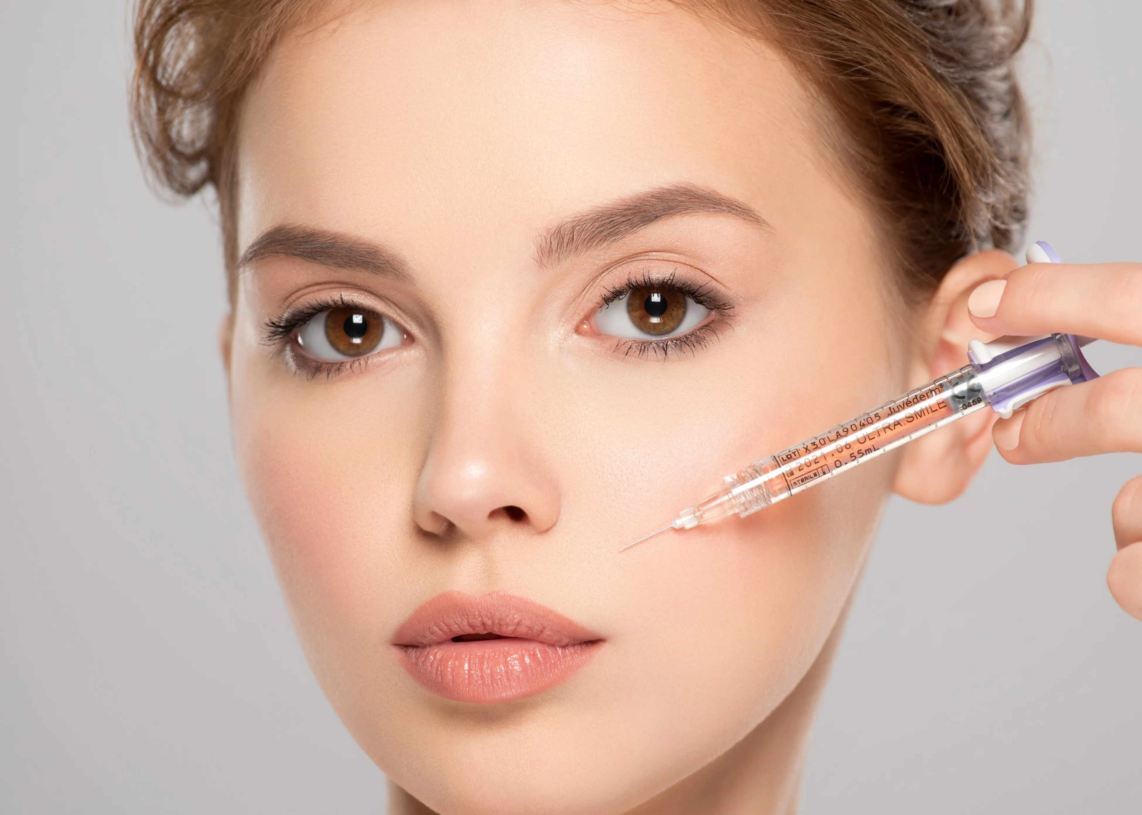 A woman is putting a needle in her eye.