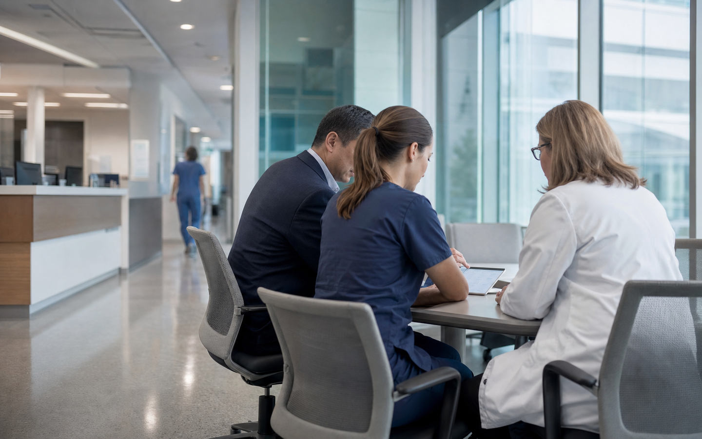 Clinical and administrative leaders reviewing data together in a modern hospital