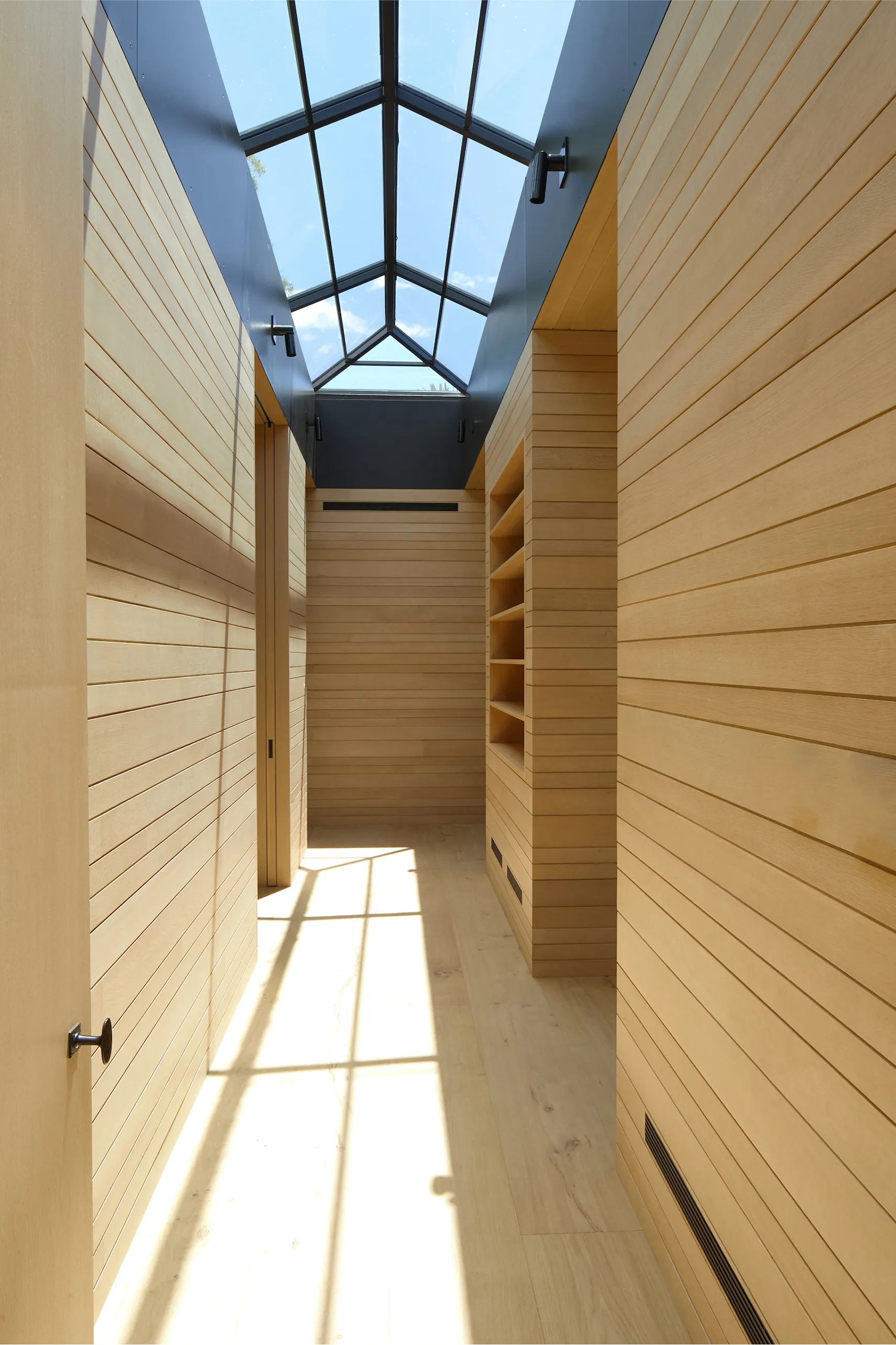 modern hallway with light wood floors