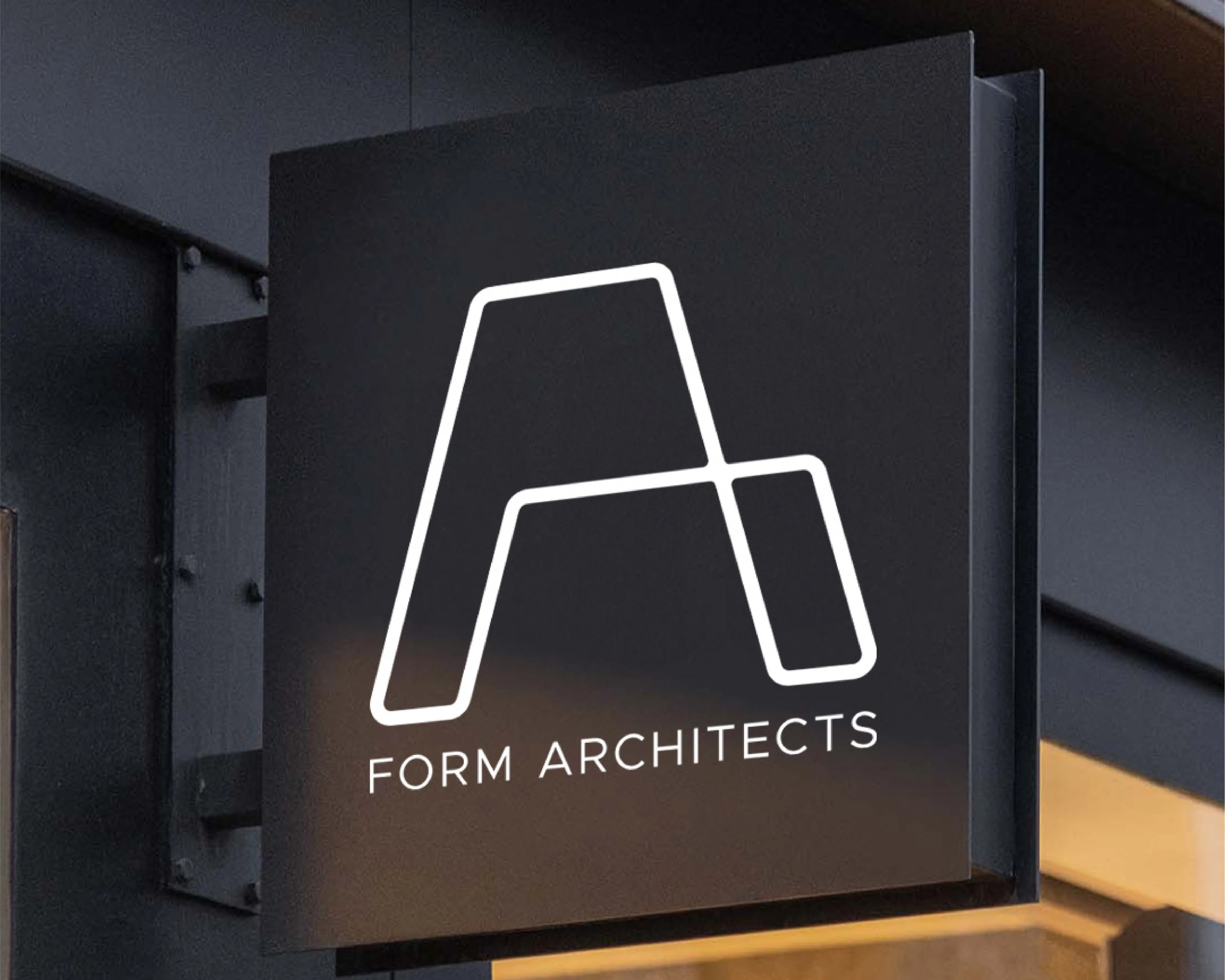 Black exterior sign with a white geometric letter A and the text 'FORM ARCHITECTS'.