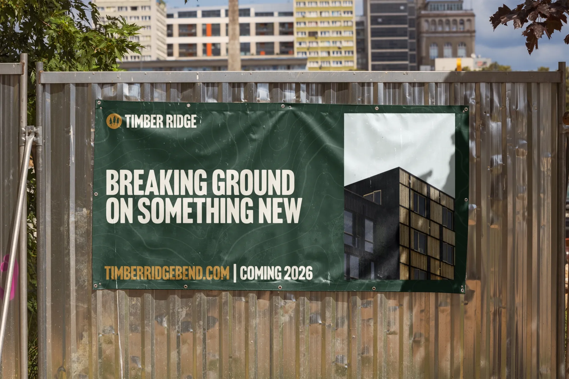 Banner on a metal fence reading Timber Ridge Breaking Ground on Something New Coming 2026 with a building image.