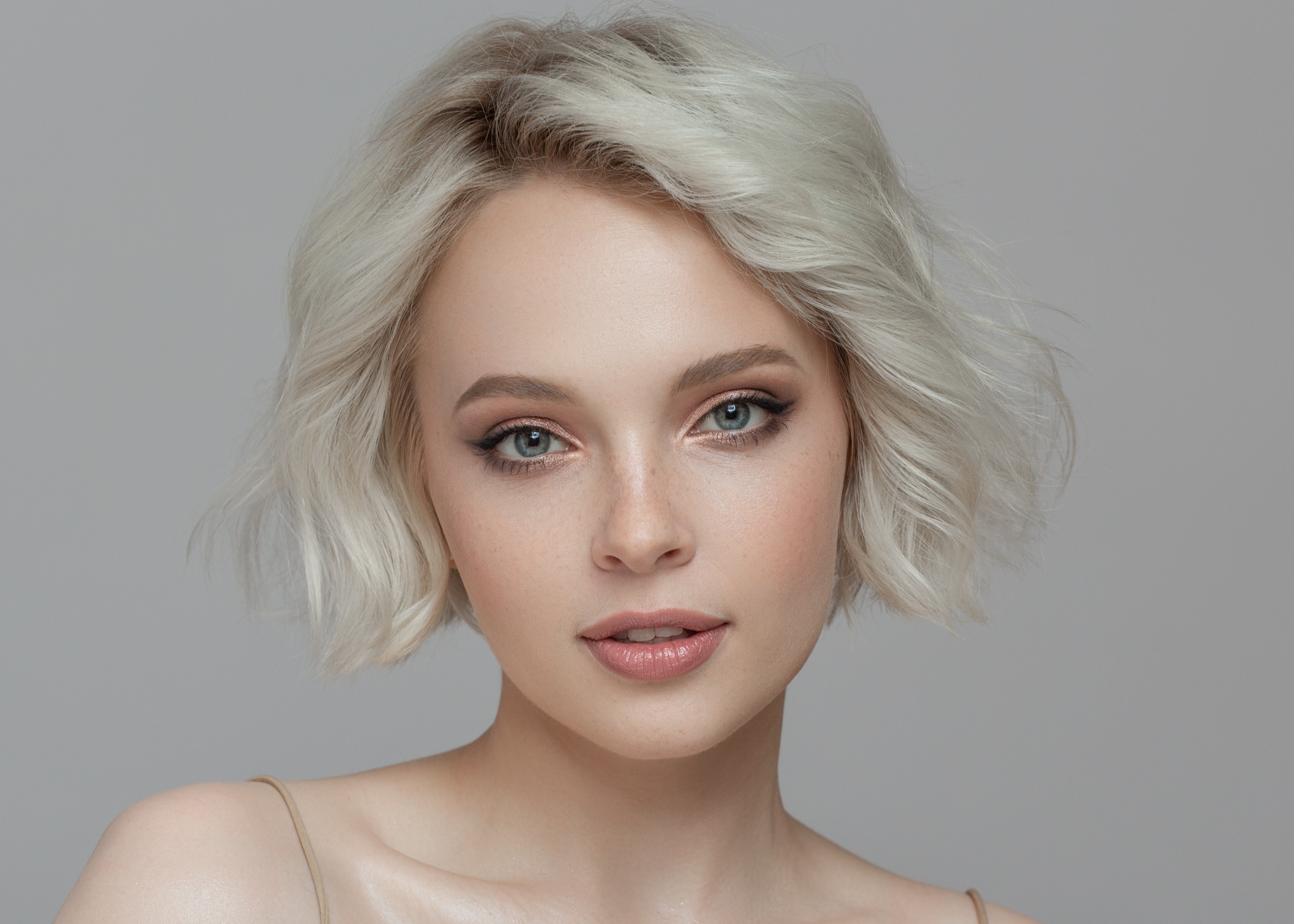 A woman with blonde hair and blue eyes.