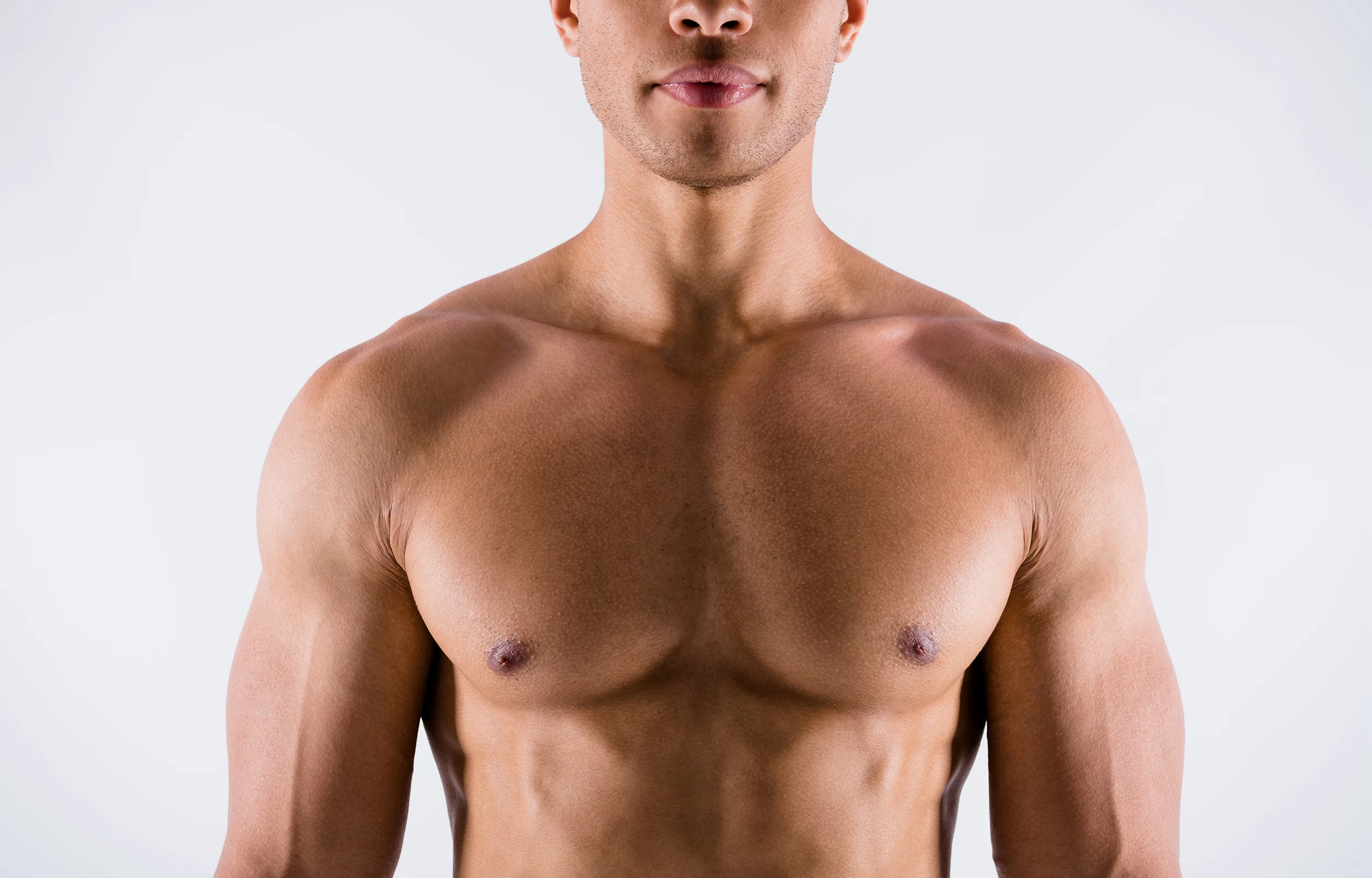 A man with no shirt on posing for a picture.