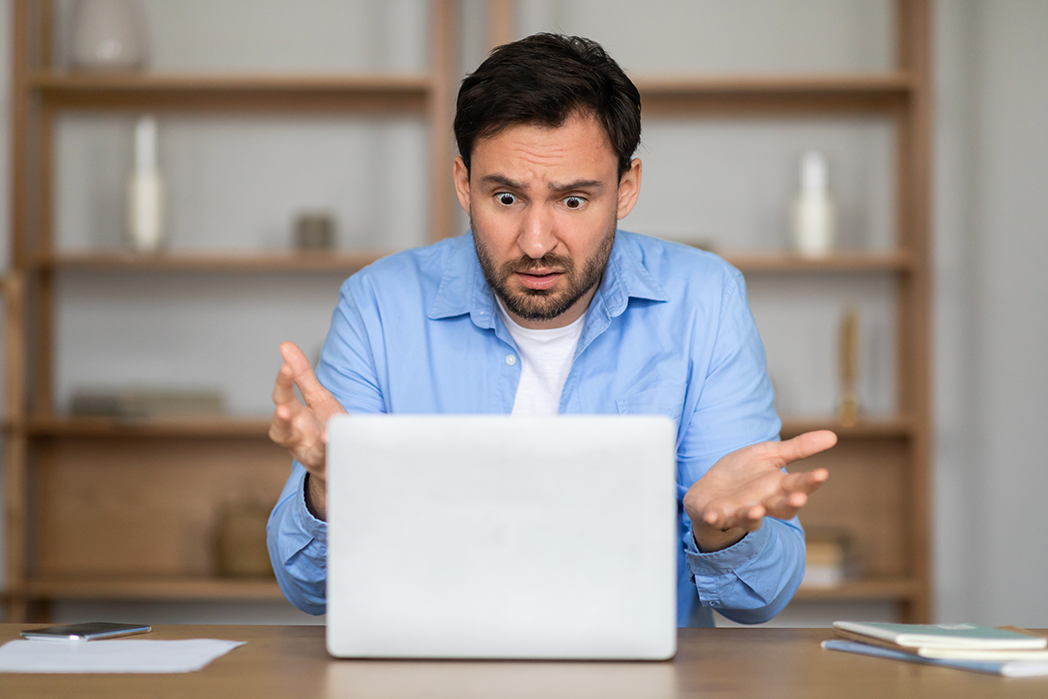 Confused person on laptop.