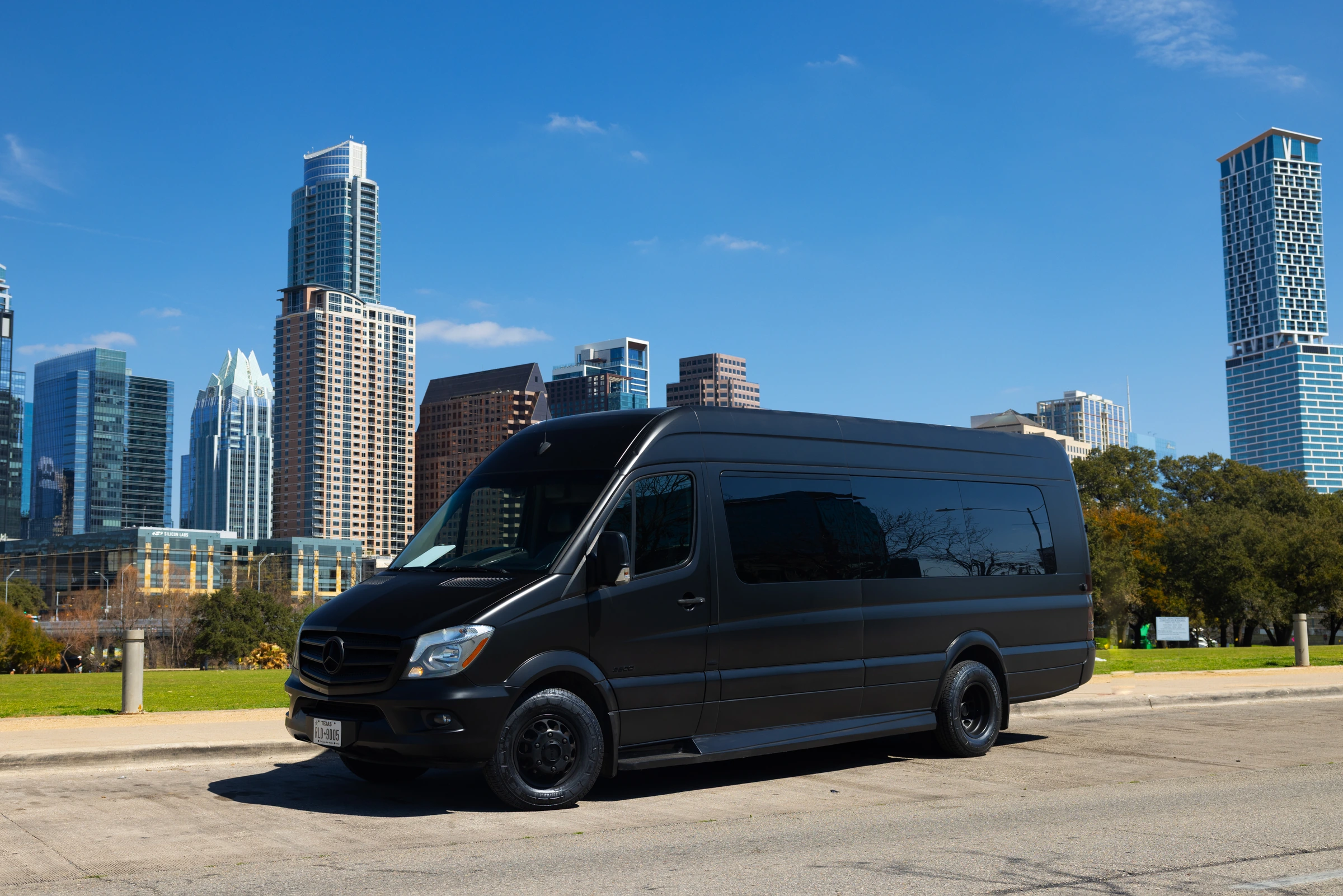 VANTA BLK matte black Mercedes-Benz Sprinter with the Austin skyline