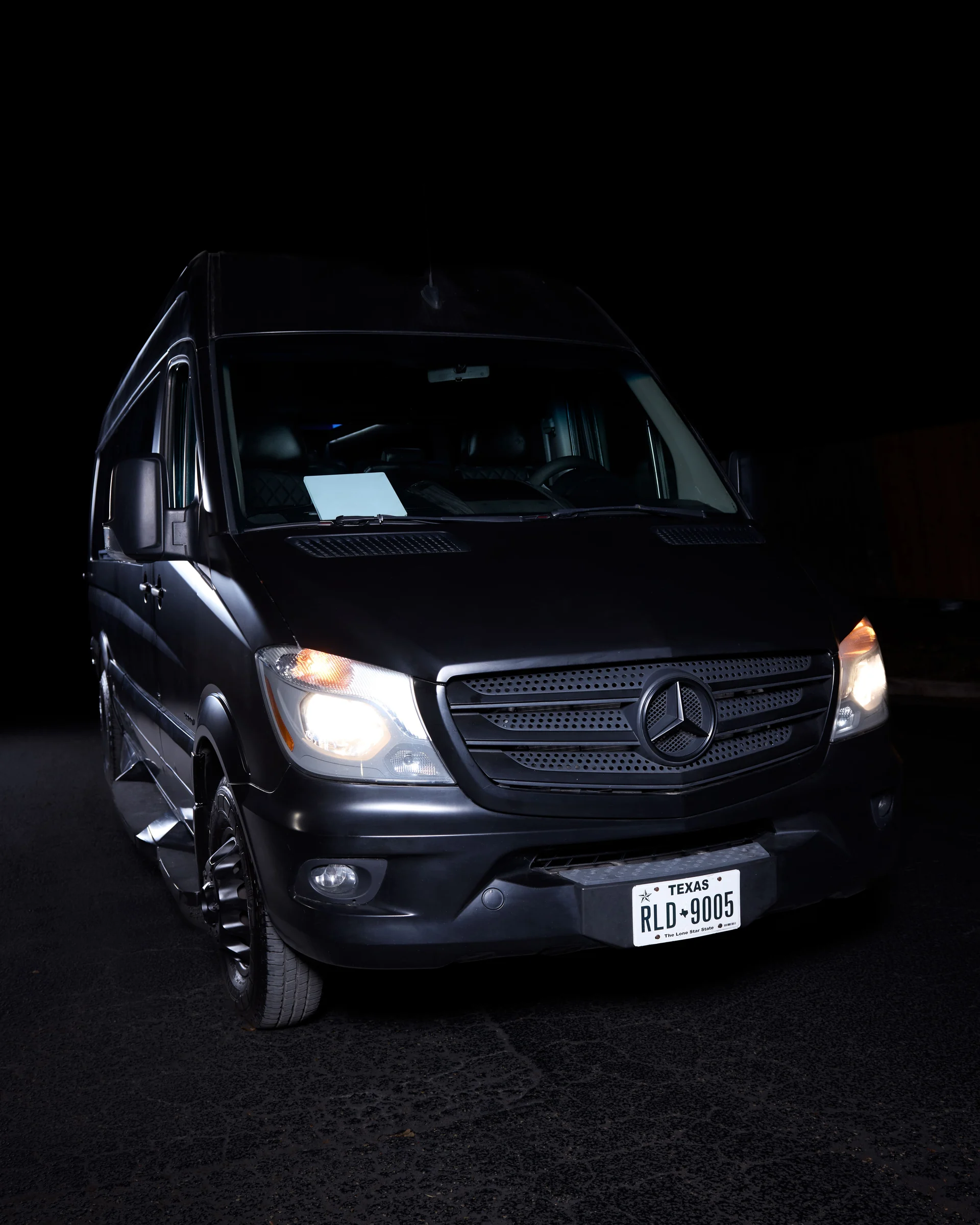 VANTA BLK matte black Mercedes-Benz Sprinter at night