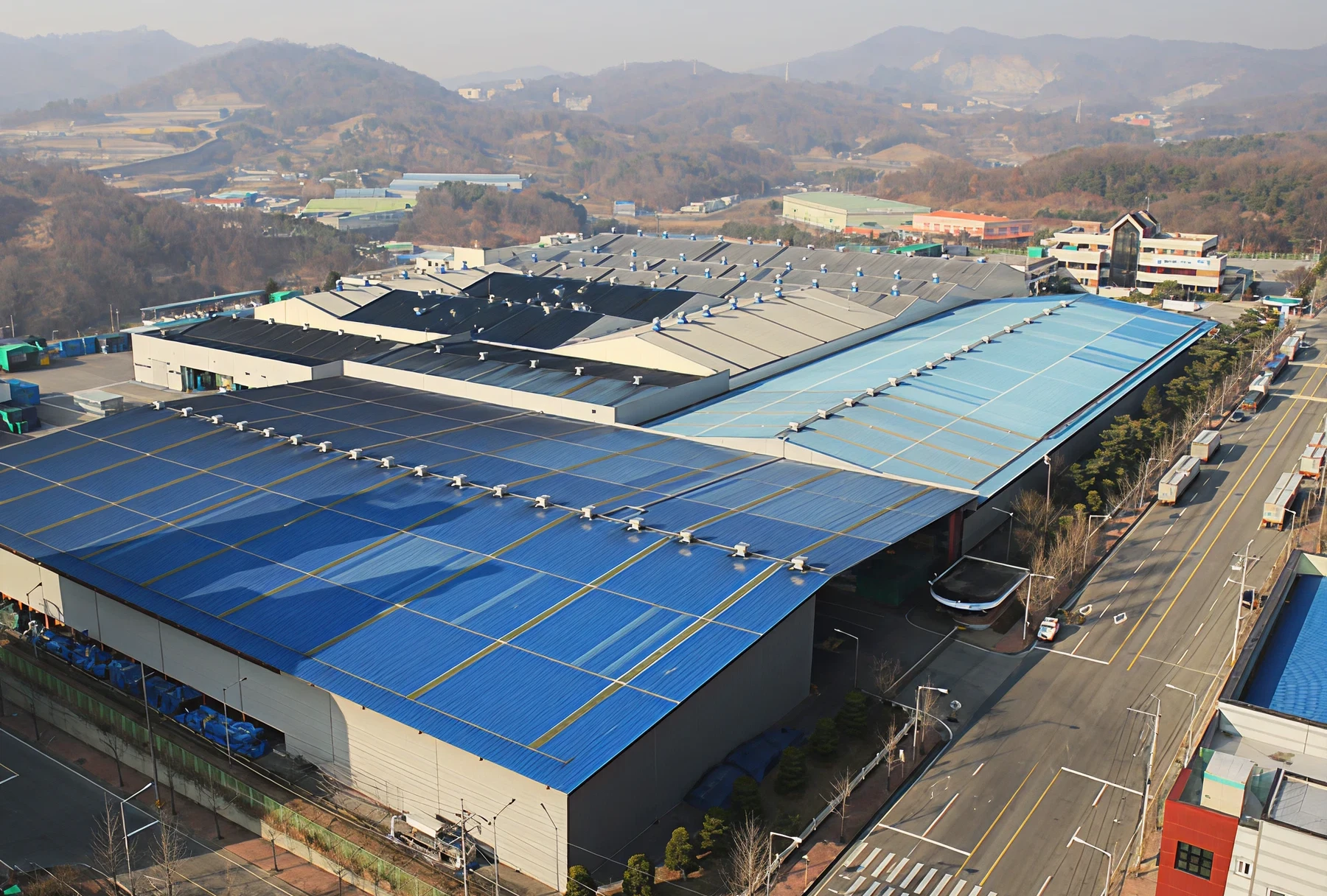 Large industrial warehouse with blue roofs