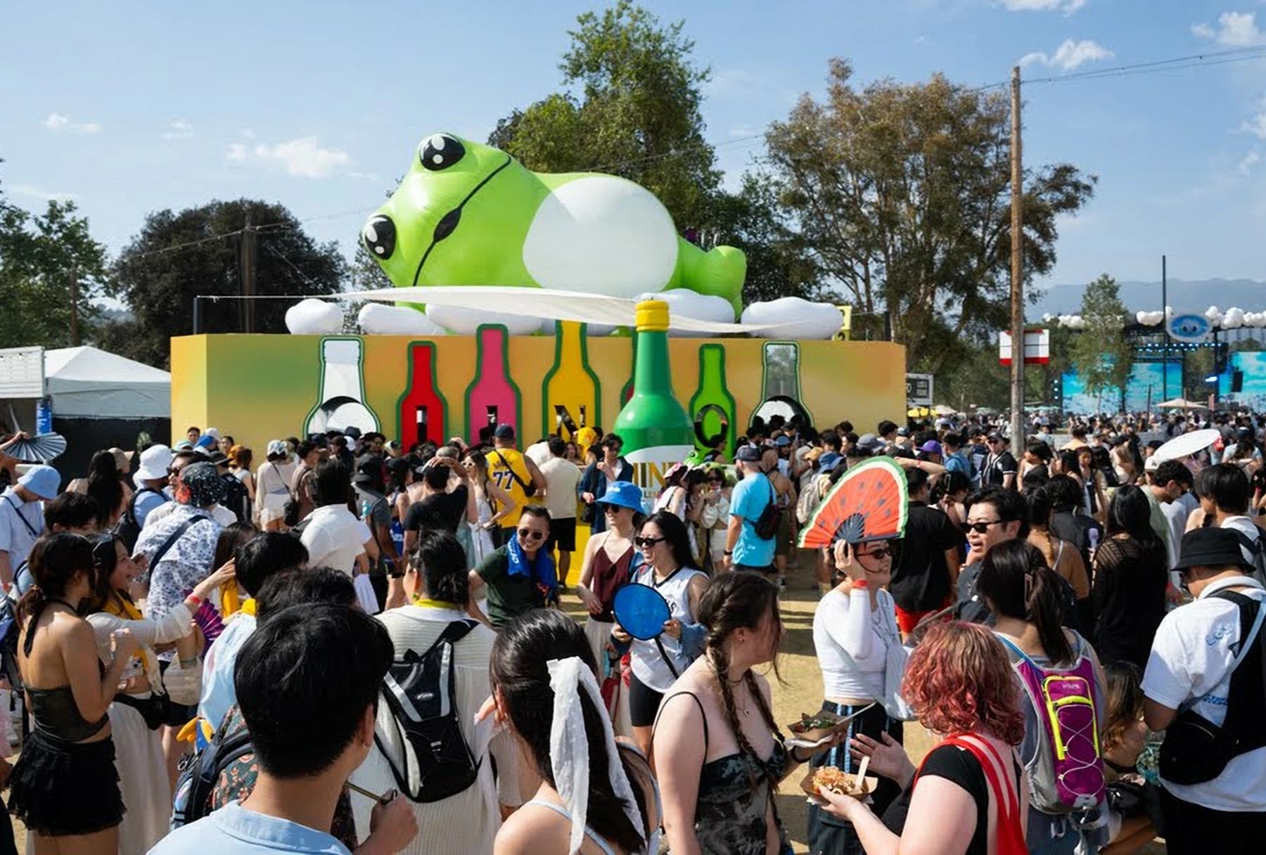 Crowd at outdoor Jinro festival with frog display