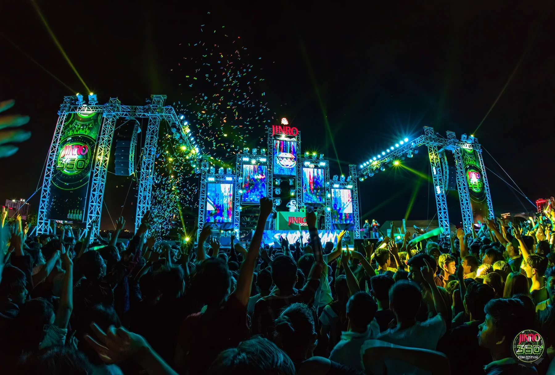 Crowd cheering under lights at the JINRO 360° music festival.