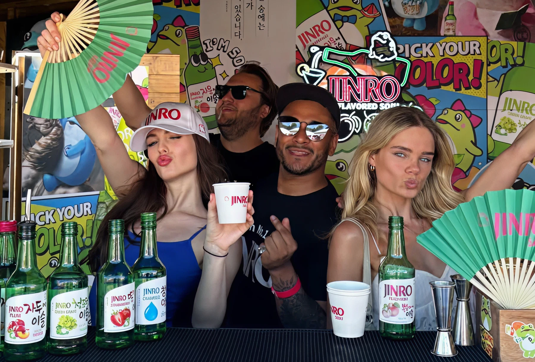 Friends enjoying JINRO drinks at a colorful booth