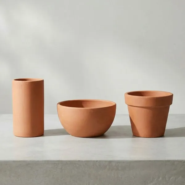 Two plant pots with similar capacity but different height and width