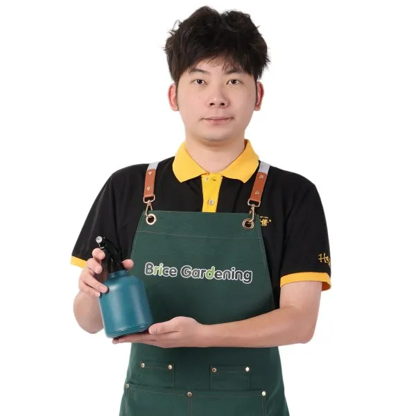 Brice Gardening team member holding a mist sprayer for plant care products