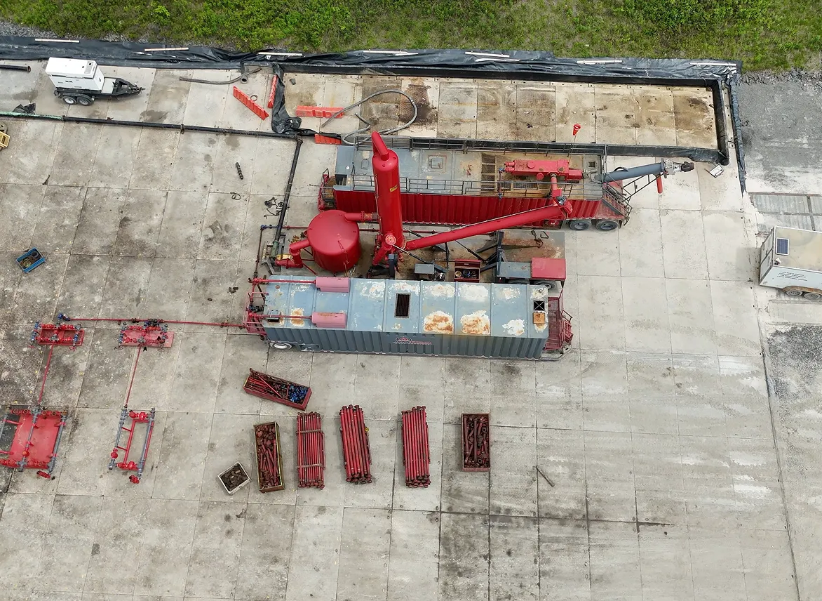 A red crane sitting on top of a cement floor.