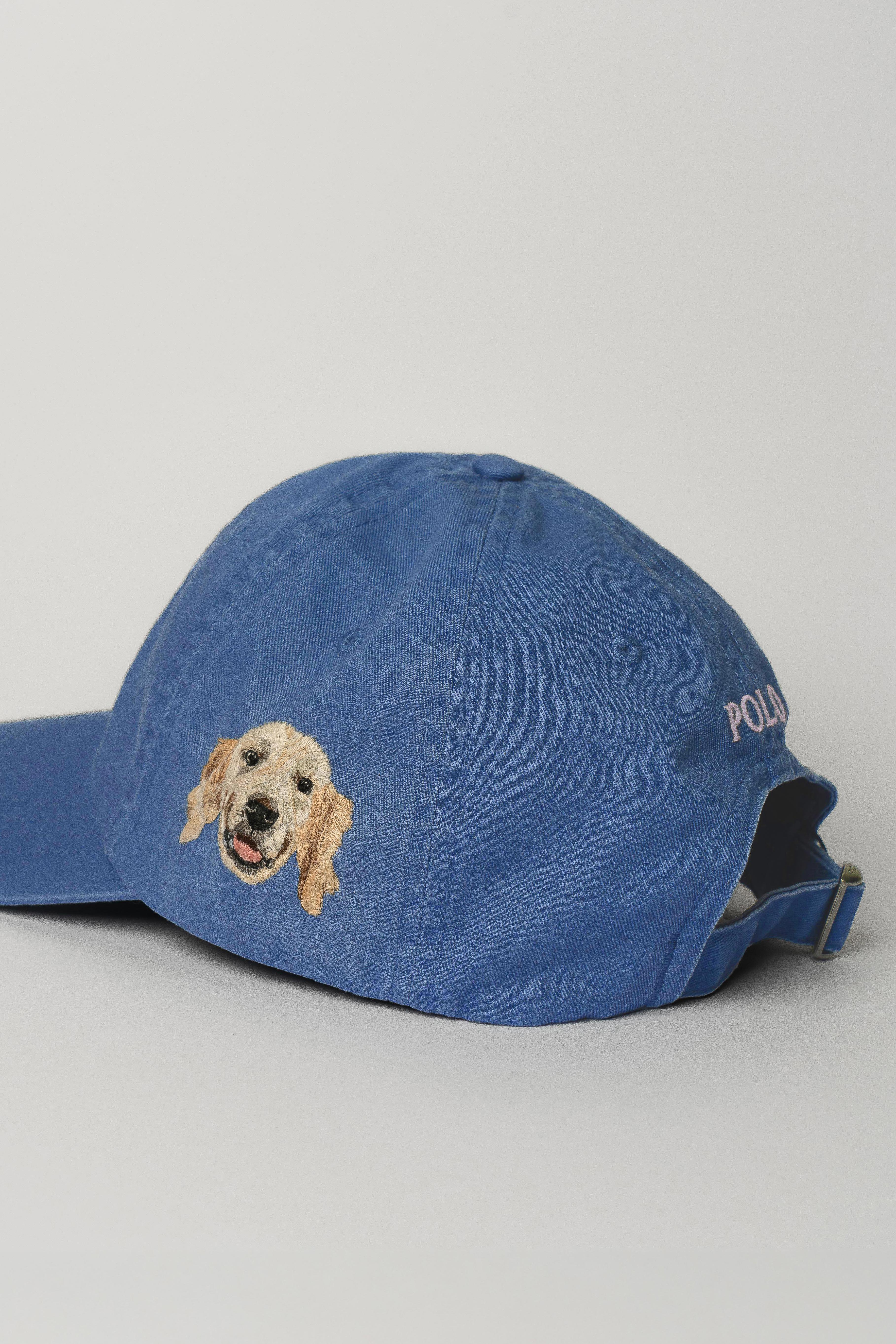 Tan baseball cap with an embroidered dog face on the side.