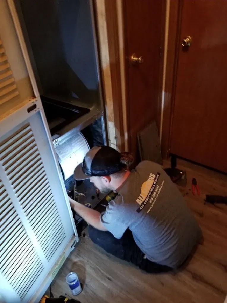 Homeowner replacing an air filter in an air conditioning system