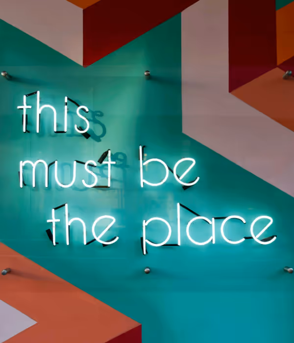 a neon sign saying the must be the place