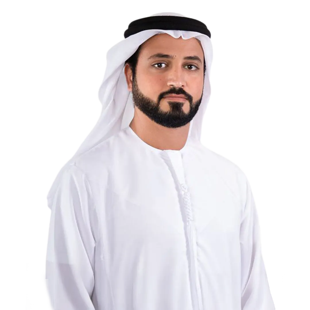 Portrait of a man wearing a traditional white kandura and white ghutra with black agal, against a white background.