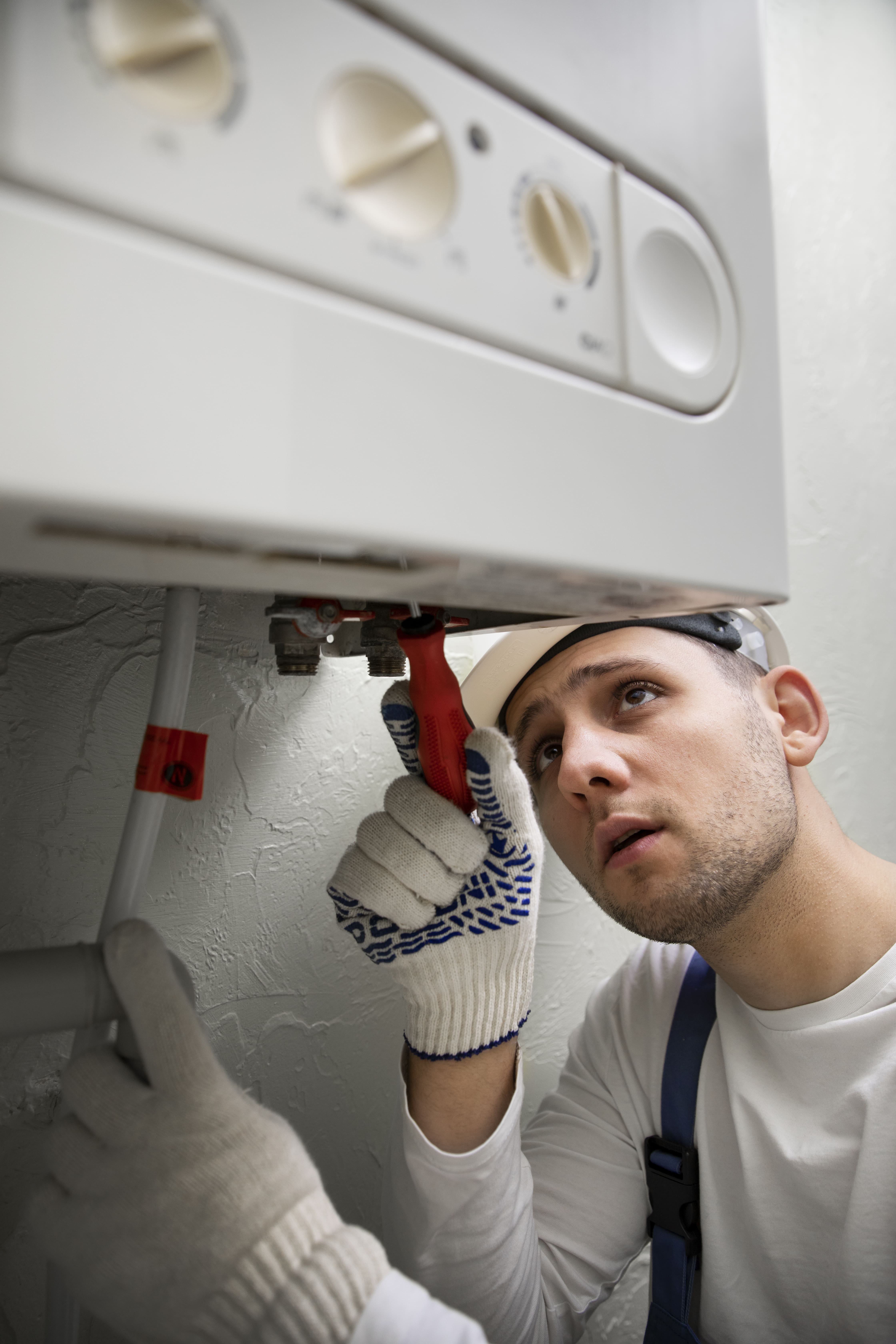 worker-repairing-water-heater