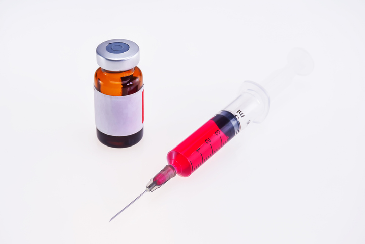 Vitamin B12 injection vial and syringe used in provider-guided treatment for vitamin B12 deficiency.