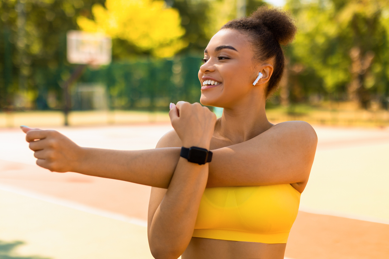 Woman stretching outdoors, representing improved energy and well-being after vitamin B12 deficiency treatment.