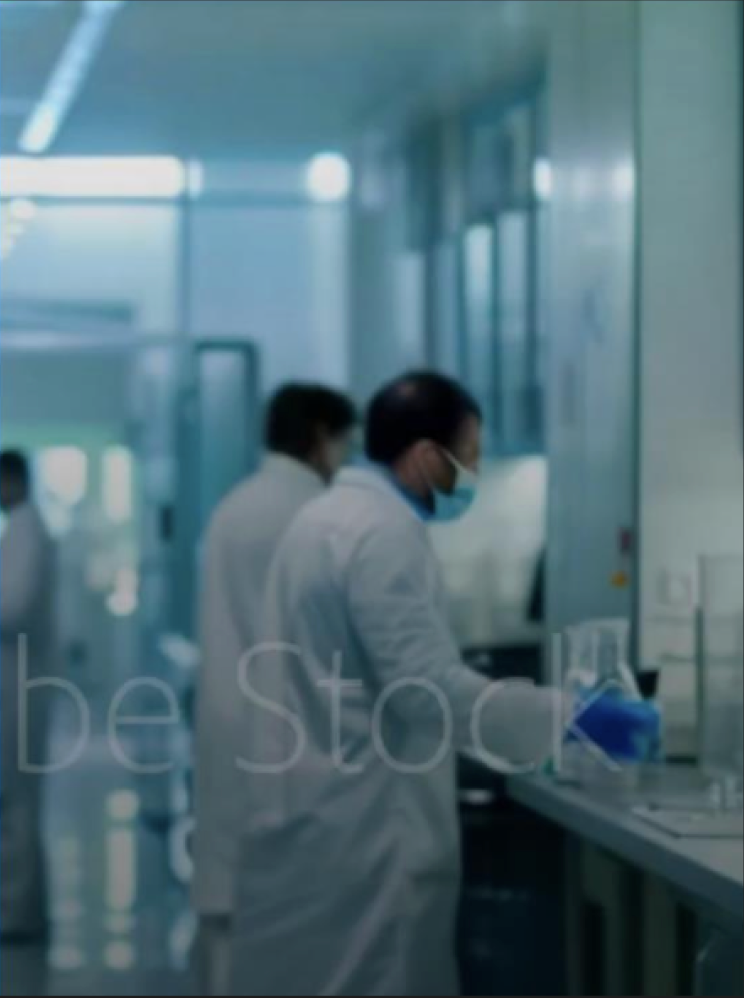 A group of people in white lab coats in a room.