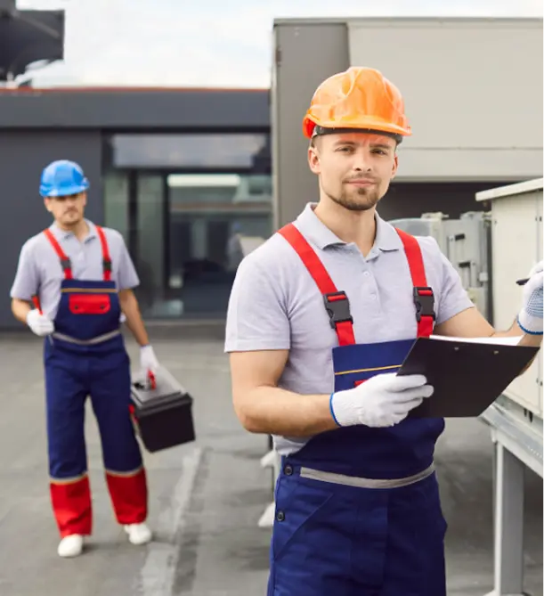 Professional HVAC technicians with clipboard on job site