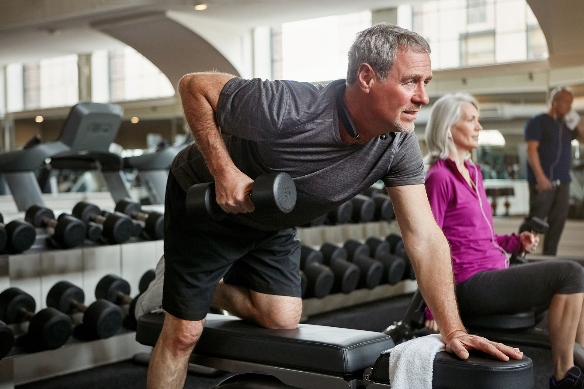 A man lifting weights in a gym