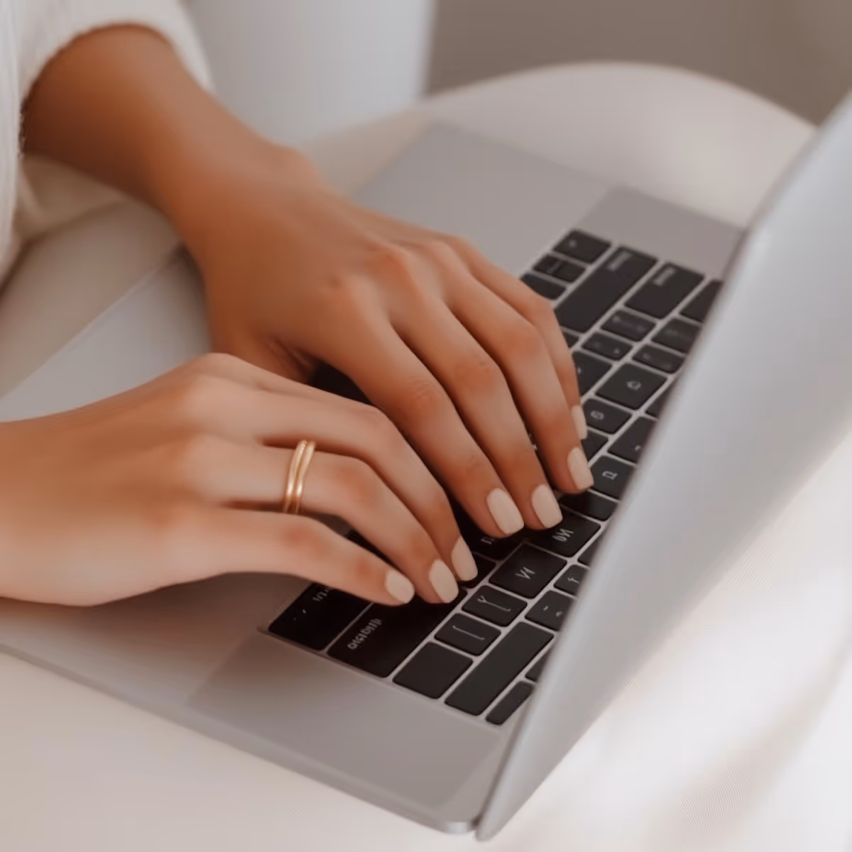 Typing on Silver Laptop