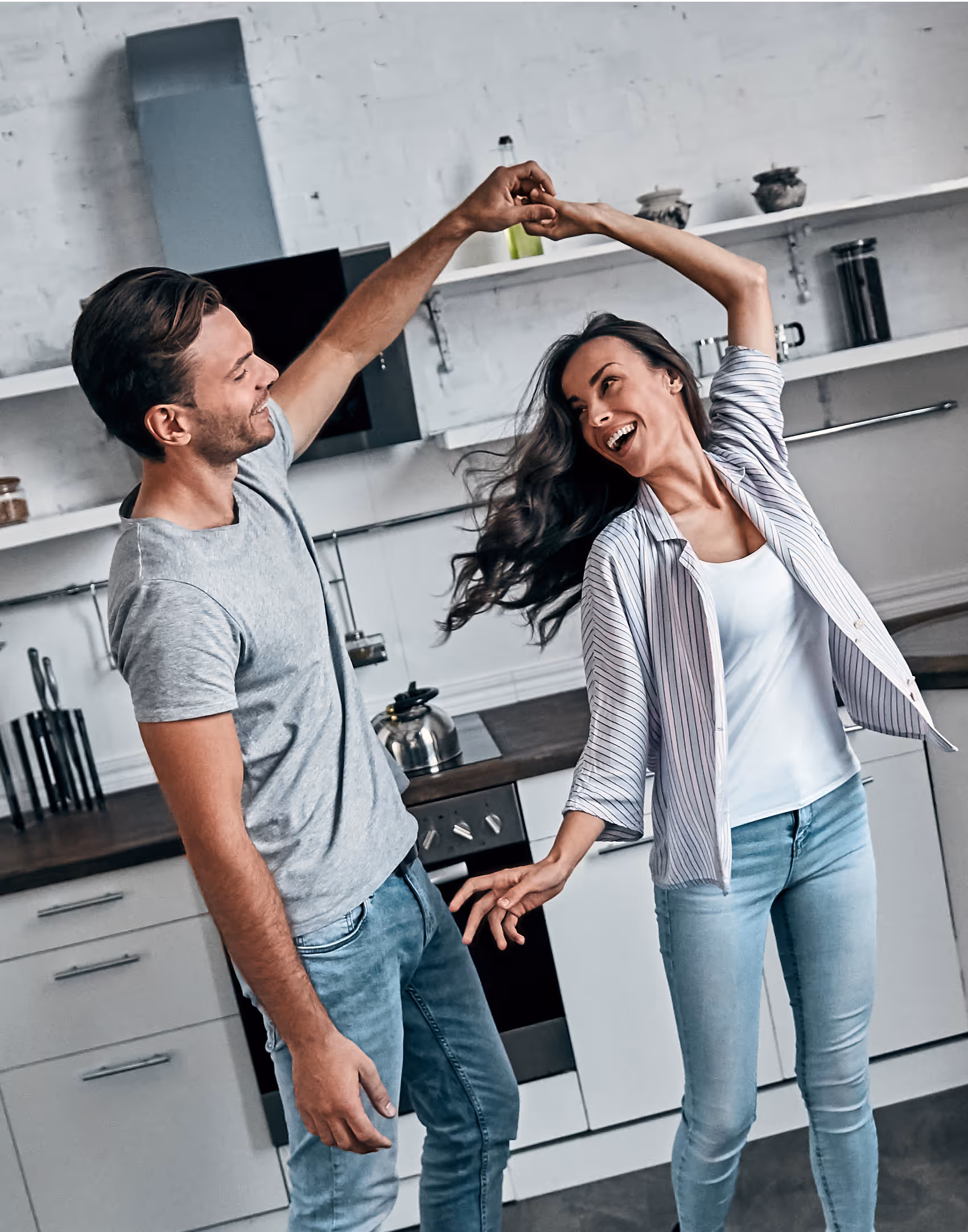 Happy family photo of couple dancing in kitchen together