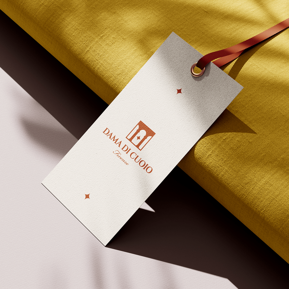 Dama di Cuoio Florence leather goods product tag with star logo design and artisanal branding on luxury packaging