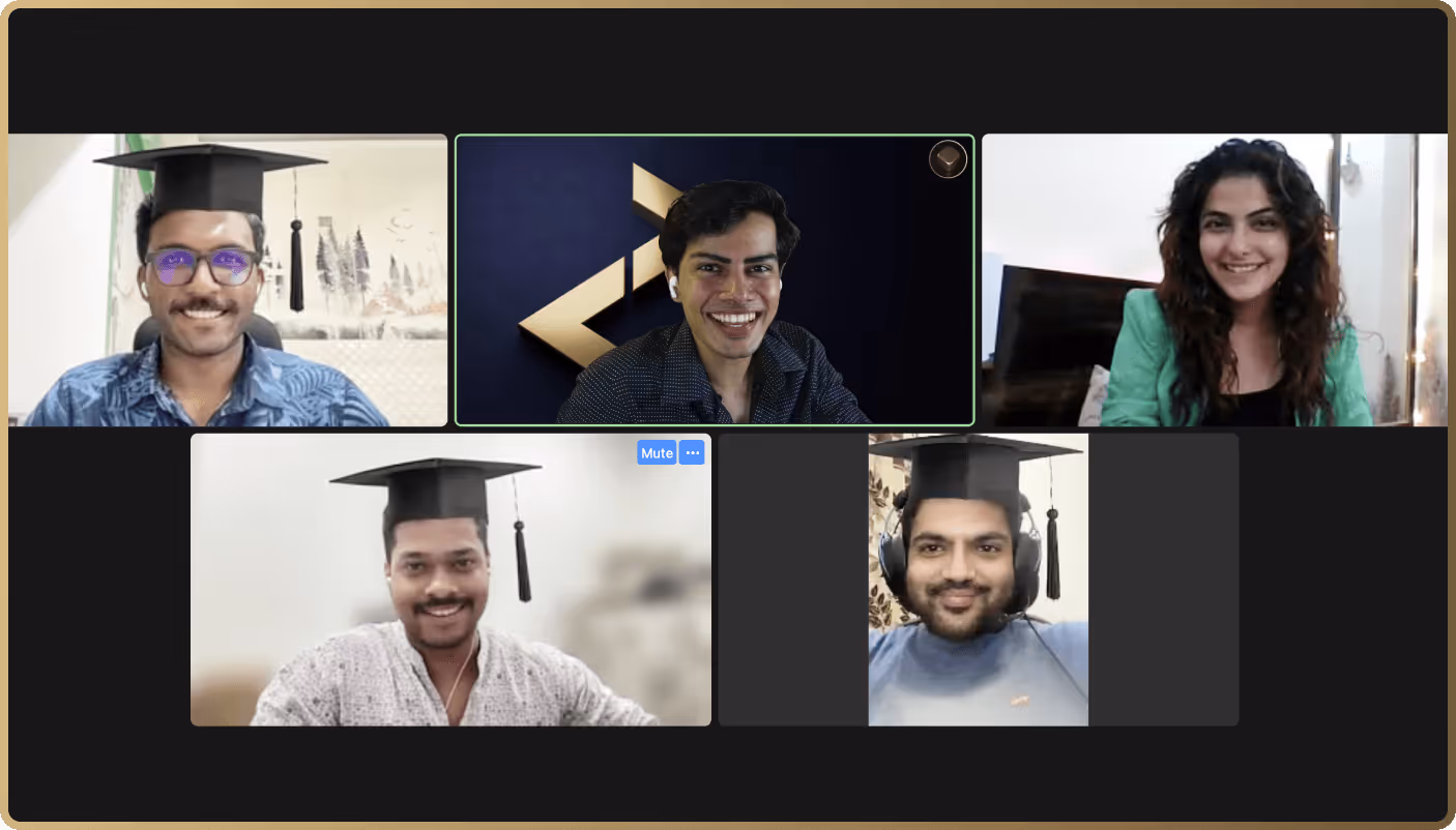 Five students in graduation caps smiling during virtual video call