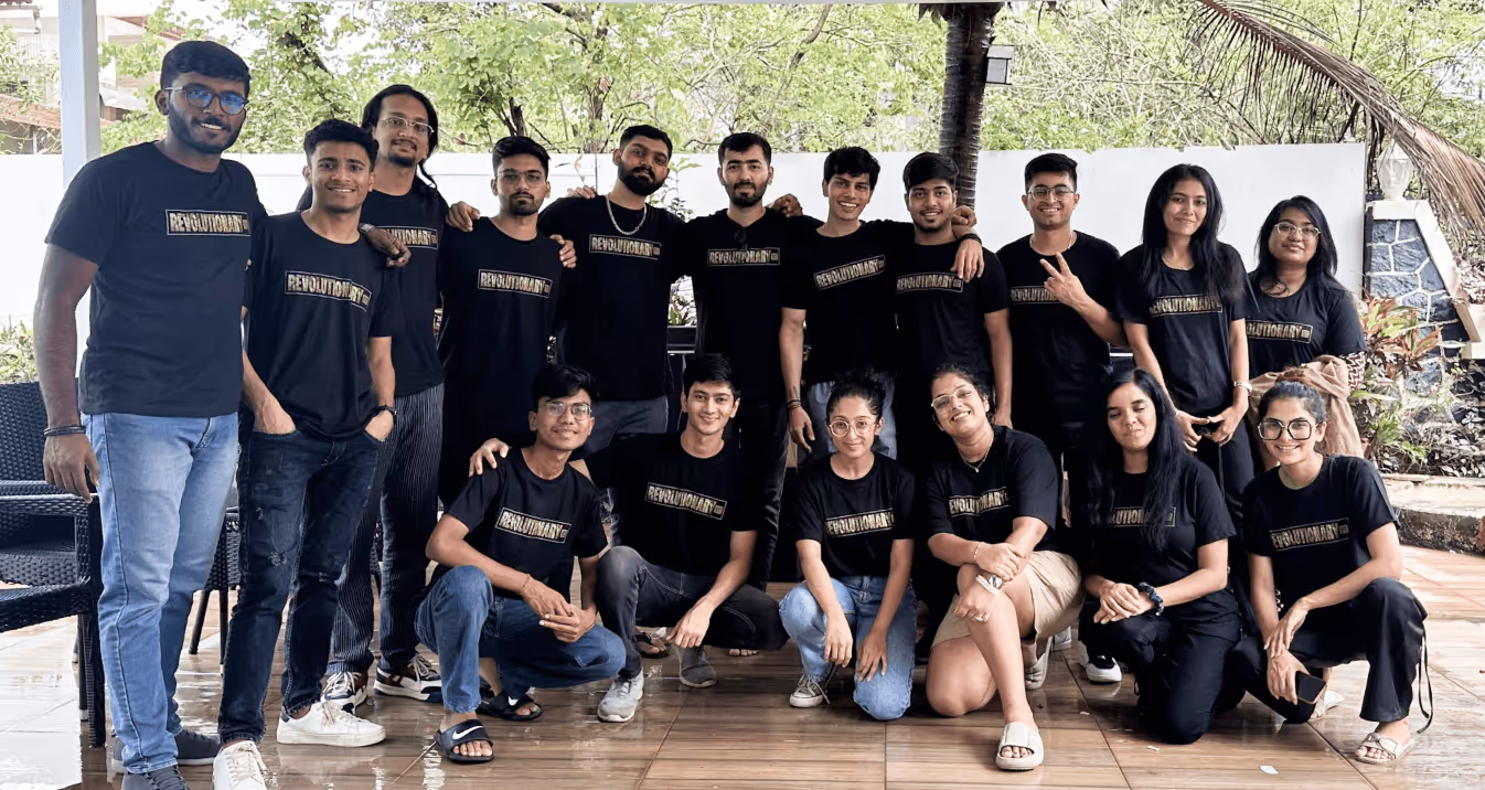 Large group photo of team wearing black Revolutionanz shirts outdoors