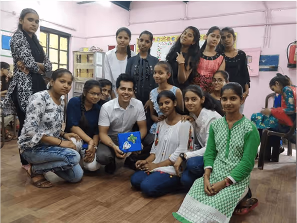 Group of students and teacher posing together in classroom