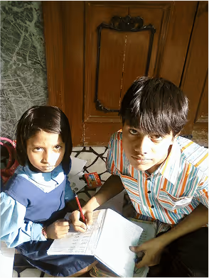 Two students studying together near wooden door