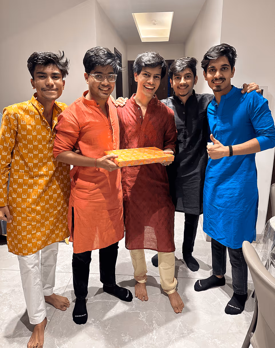 Five friends in colorful traditional kurtas celebrating together