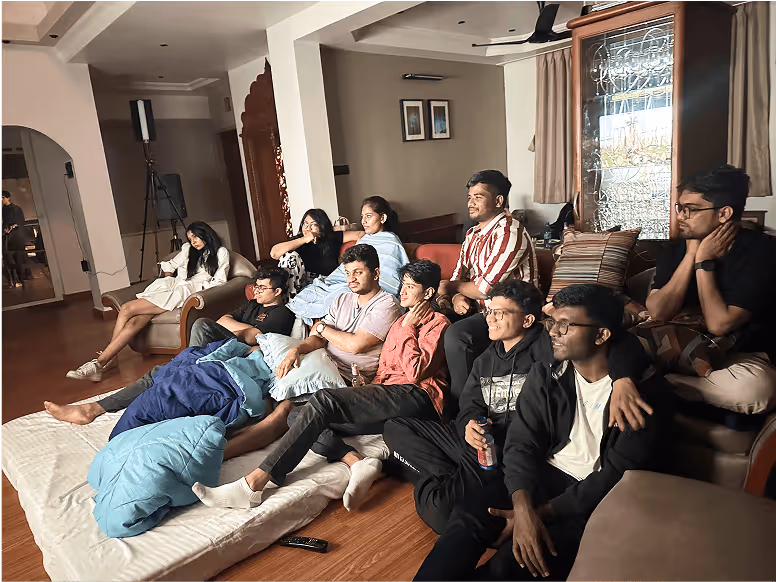 Group of friends lounging together in a living room, relaxed and comfortable