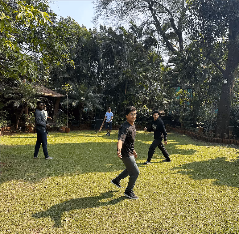 People practicing tai chi or qigong in a lush green garden
