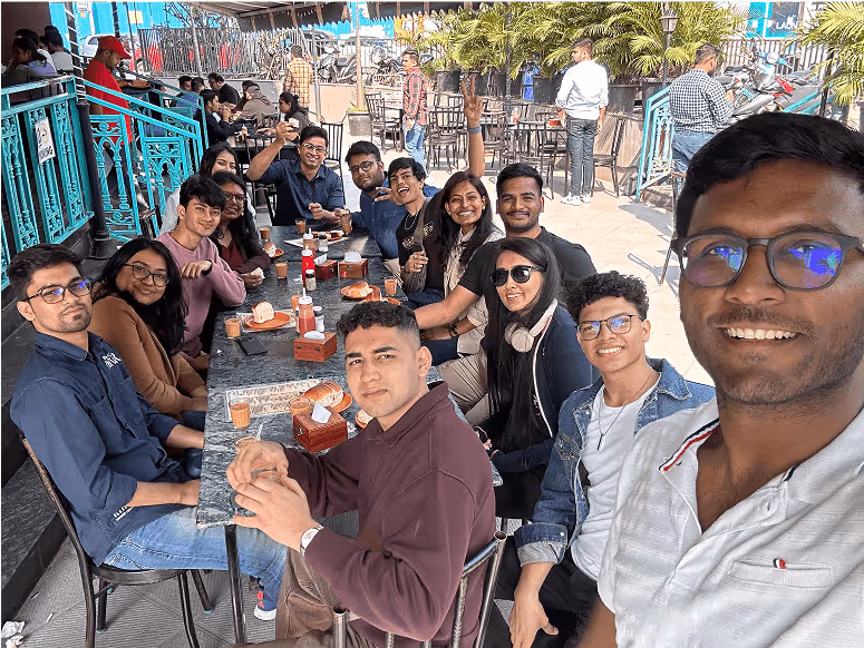 Large group of friends enjoying drinks together at an outdoor cafe