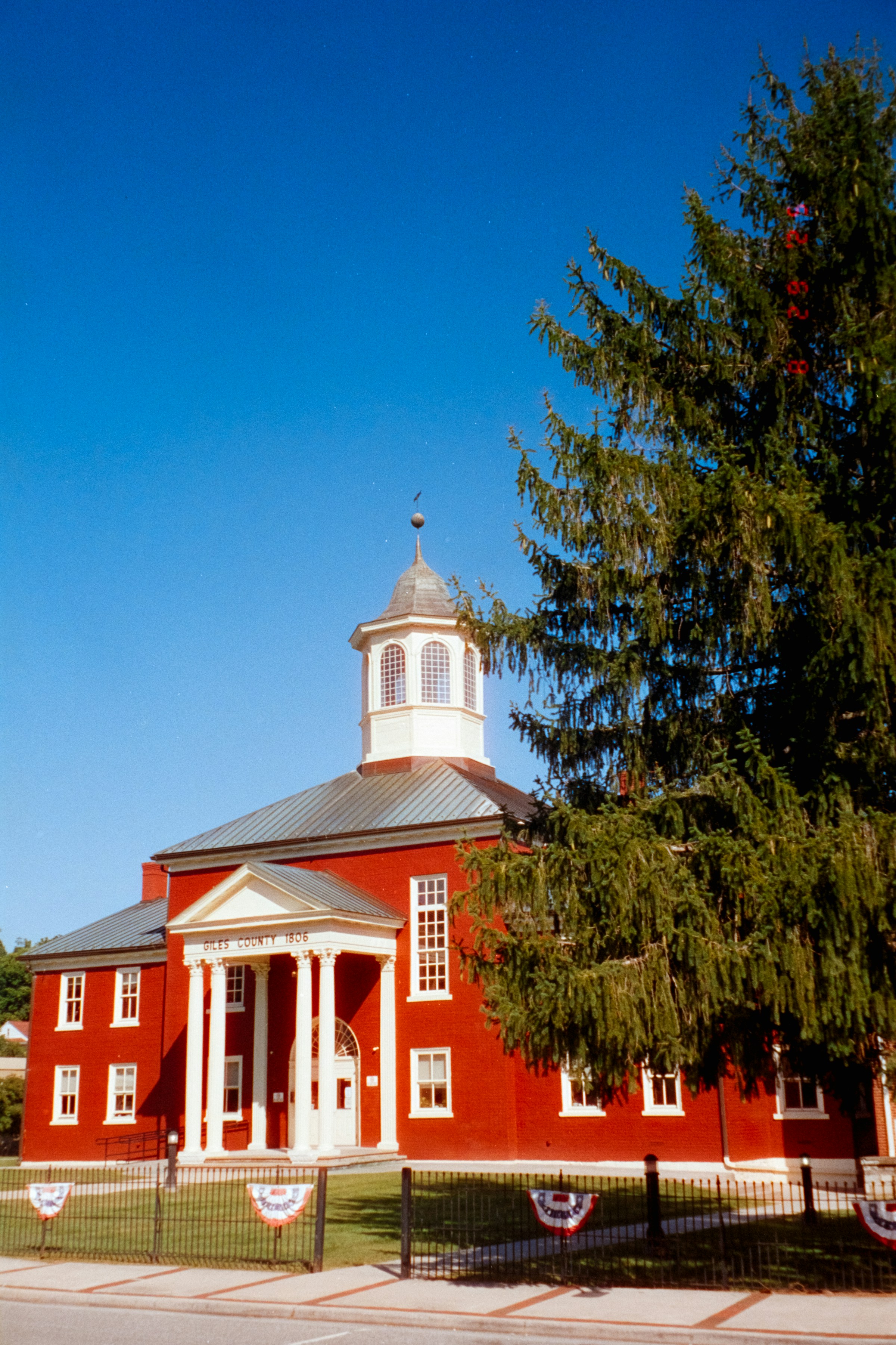 Historic courthouse with red brick, white columns and a domed roof, representing legal reform for animals