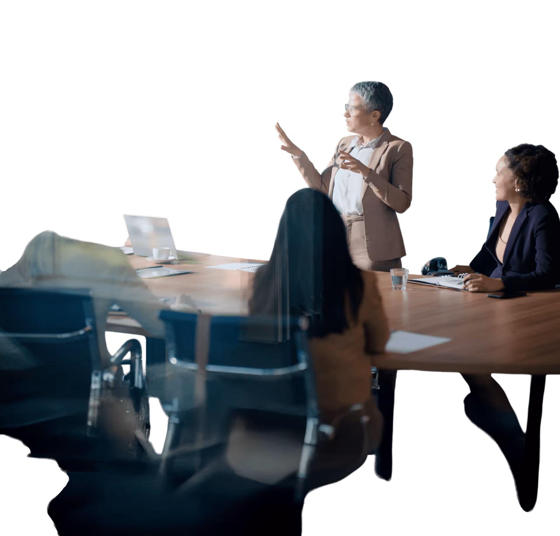 Reflection of people in a meeting room with blue chairs and a wooden conference table.