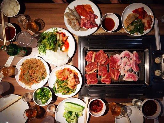 Picnic Garden Flushing all-you-can-eat Korean BBQ spread with galbi, pork belly, japchae, banchan, and soju