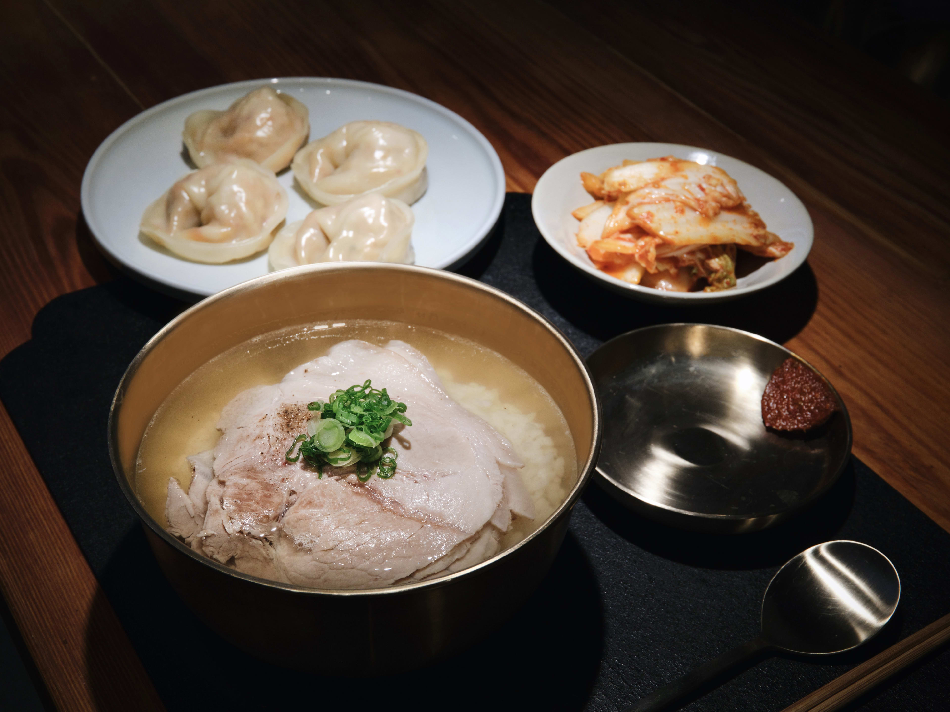 Okdongsik NYC dwaeji gomtang, a clear Korean pork bone broth, served with kimchi mandu