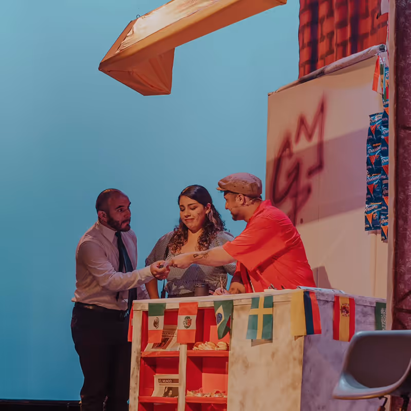 A group of people standing around a table.