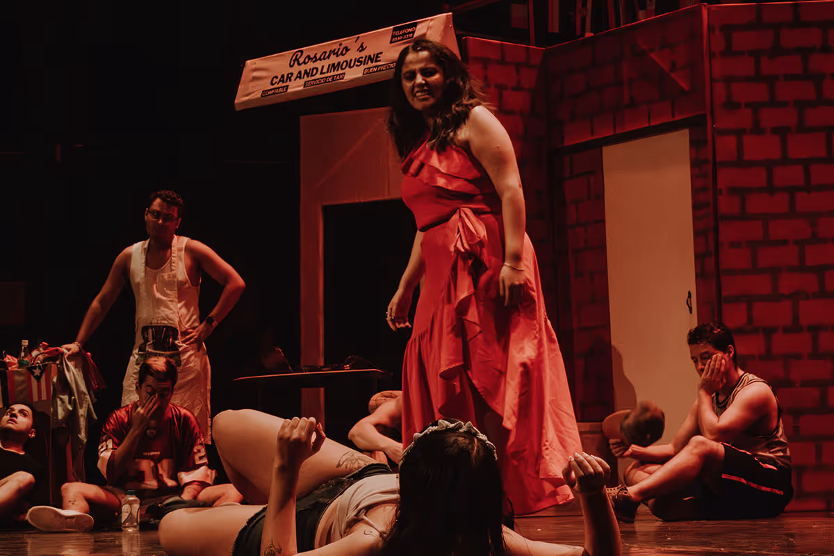A woman in a red dress standing on a stage.