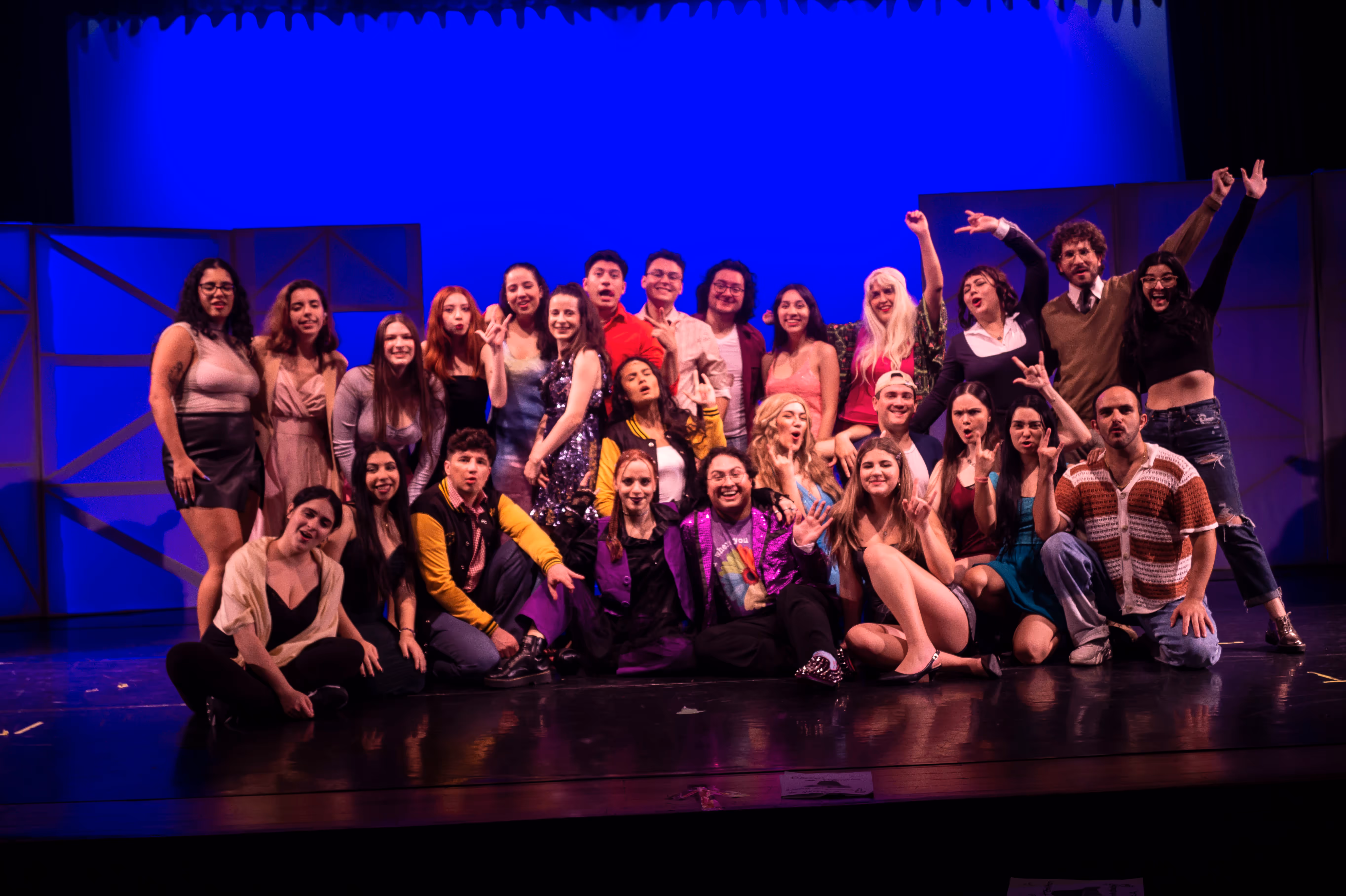A group of people posing for a picture on a stage.