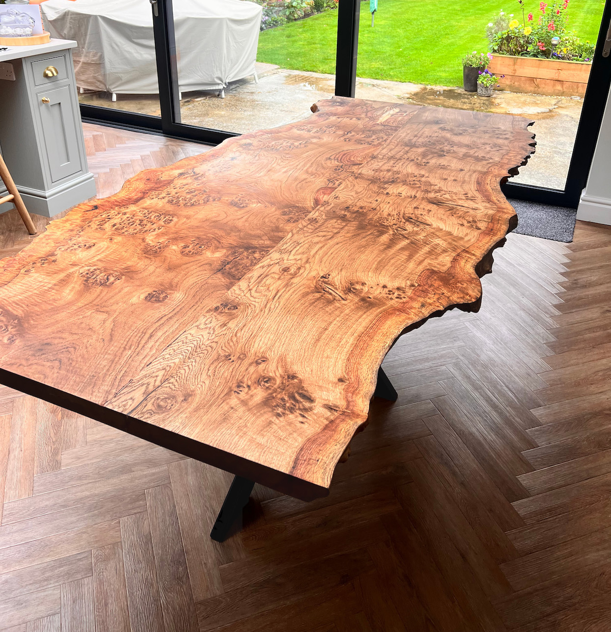 Burr walnut live-edge dining table with high-gloss finish