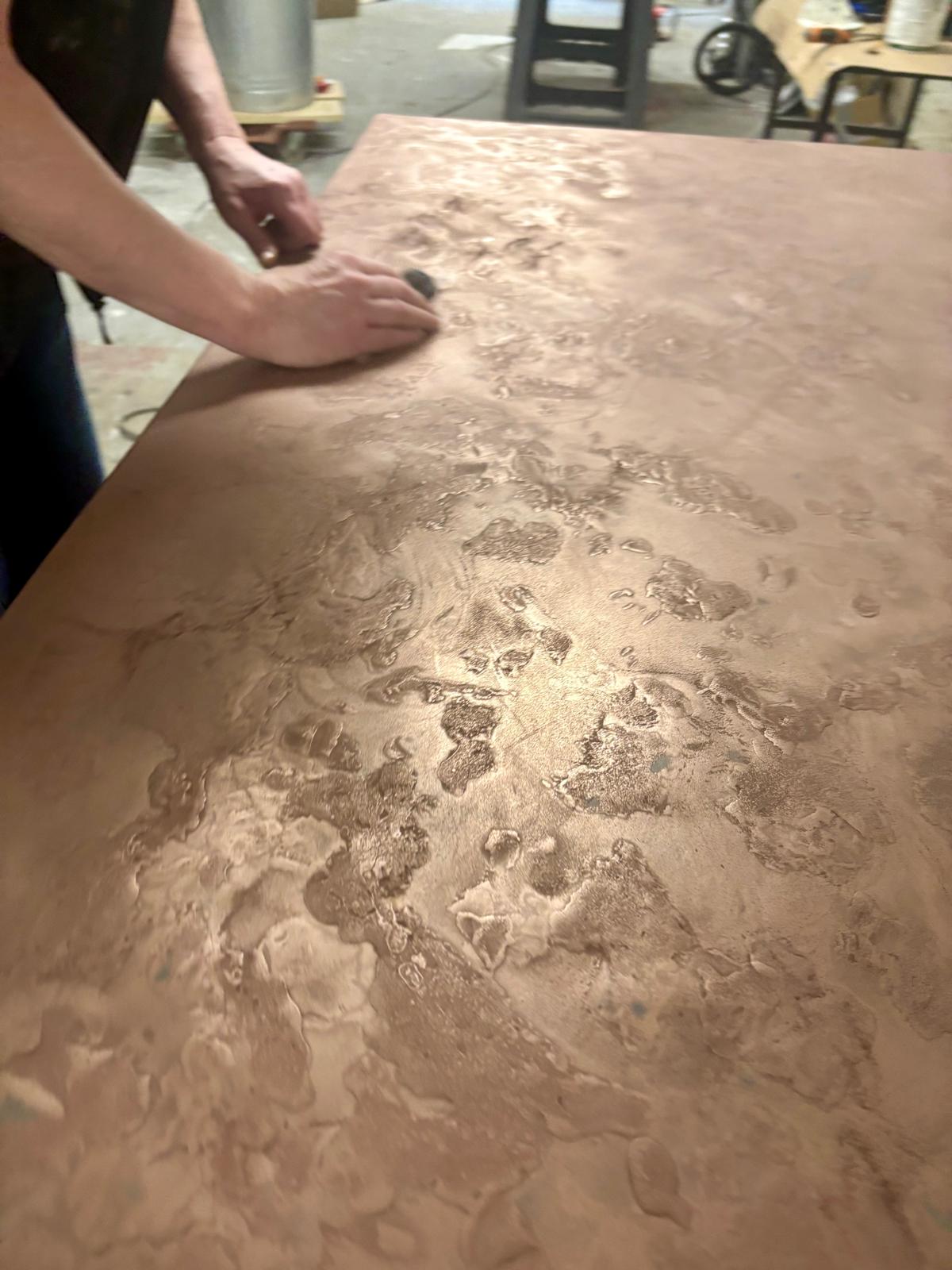 Polished concrete tabletop with inlaid metal strip detail