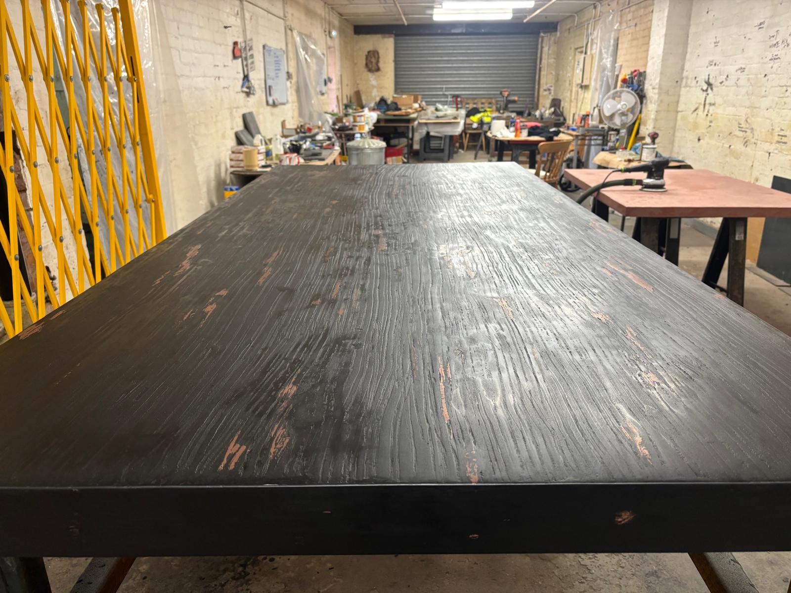 Concrete and metal alloy dining table styled in modern interior