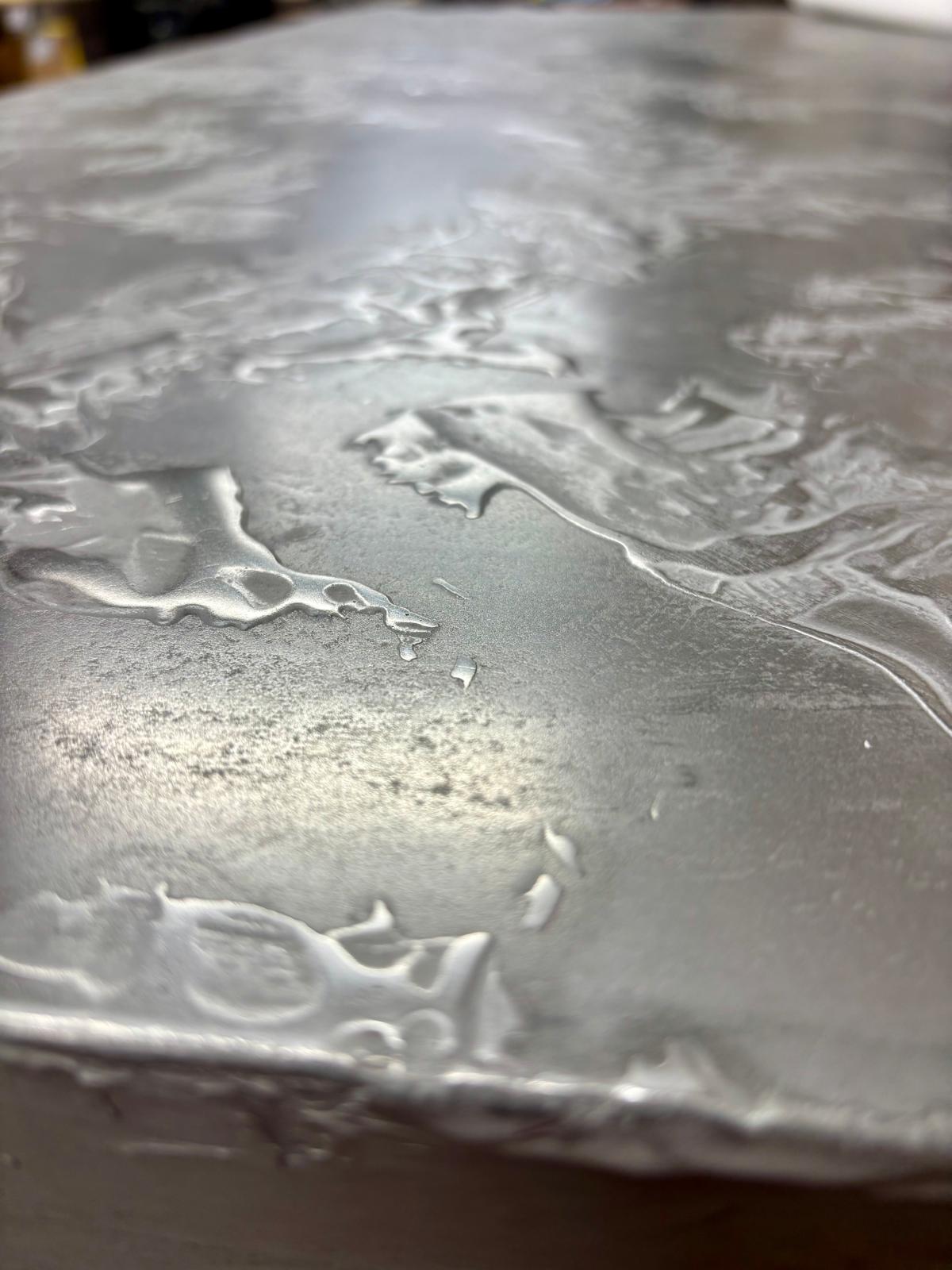 Polished concrete tabletop with inlaid metal strip detail
