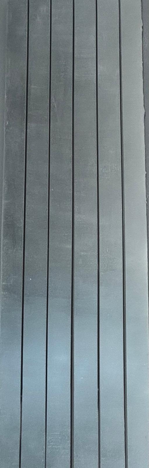Close-up of brushed metal base beneath concrete tabletop